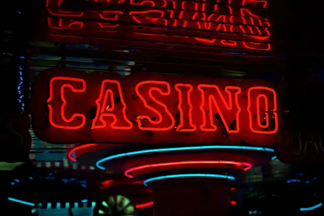 A red neon casino sign glowing in the dark, representing a Las Vegas resort
