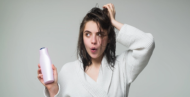 Medicated shampoo bottles on a bathroom shelf — MG217 coal tar shampoo class action settlement